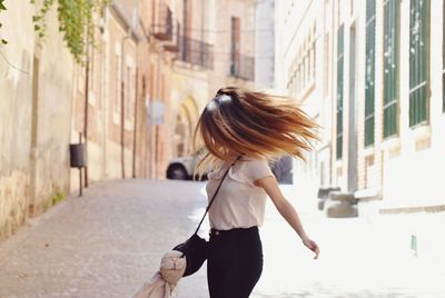 Woman walking on street in city
