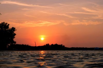 Scenic view of sea against orange sky