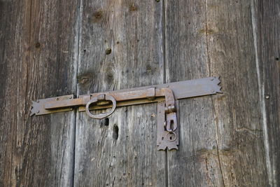 Close-up of padlock on wooden door