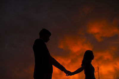 Silhouette people against sky during sunset