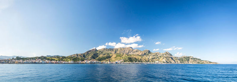 Scenic view of sea and mountains against sky