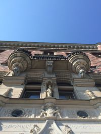 Low angle view of building against clear blue sky