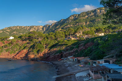 Scenic view of sea and mountains against sky