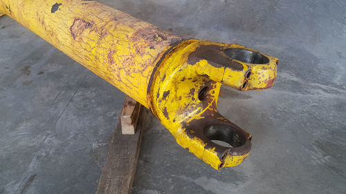 High angle view of yellow pipe on metal