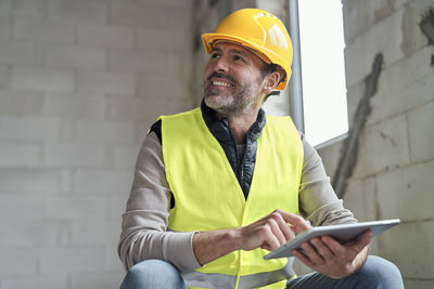 Man using digital tablet at site