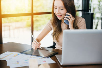 Businesswoman using laptop on table