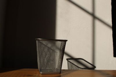 Close-up of chair on table against wall