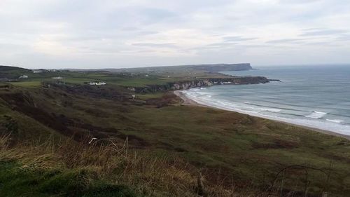 Scenic view of sea against cloudy sky