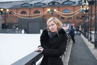 Portrait of young woman standing on snow