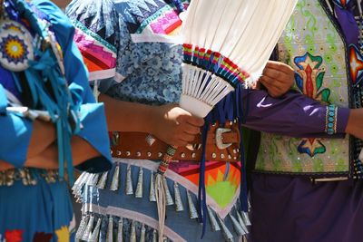 Rear view of woman standing with multi colored umbrella