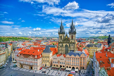 Aerial view of townscape against cloudy sky