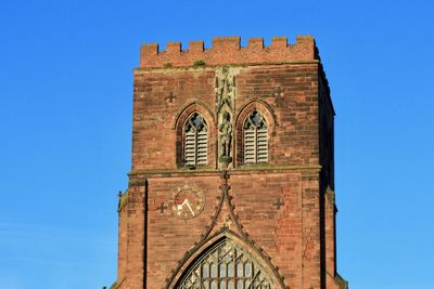 Low angle view of abbey clock tower against clear sky