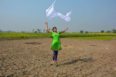 Full length of boy standing on field