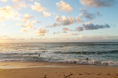 Scenic view of beach against sky during sunset
