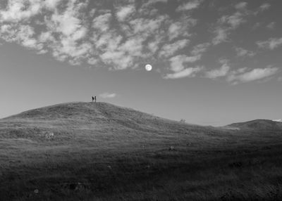 Scenic view of full moon over field against sky