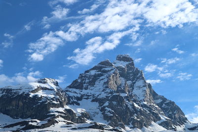 Low angle view of snowcapped mountain against sky