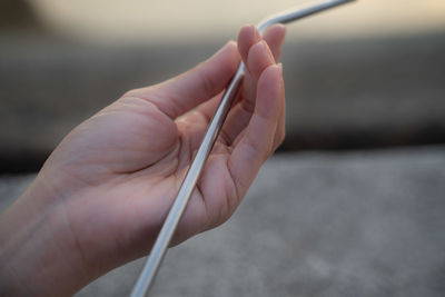 Close-up of hand holding cigarette