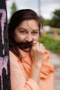 Close-up portrait of smiling woman outdoors