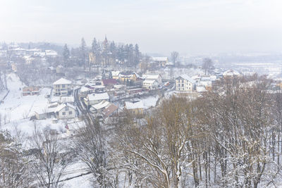 High angle view of trees and buildings against sky during winter