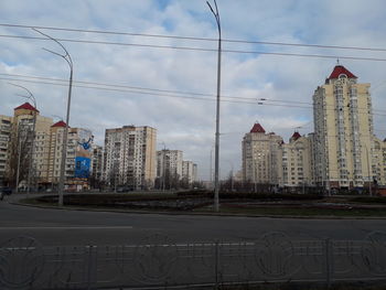 City street and buildings against sky