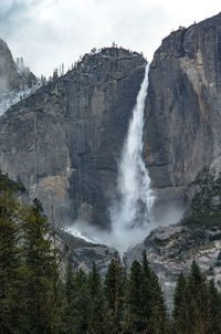 Scenic view of waterfall against sky