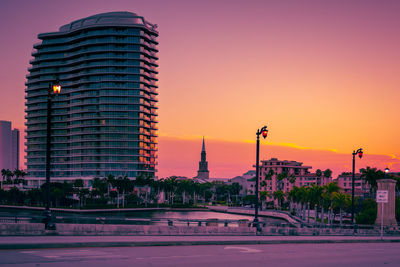 Low angle view of buildings against sky during sunset