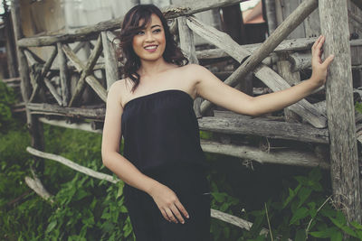 Portrait of smiling young woman standing outdoors