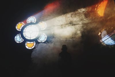 Light beam through circular stained glasses in the dark