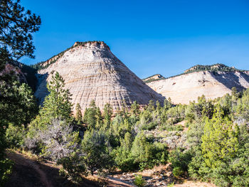 Scenic view of rocky mountains against blue sky