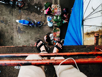 Low section of man standing on balcony