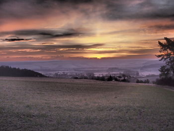 Scenic view of landscape against cloudy sky