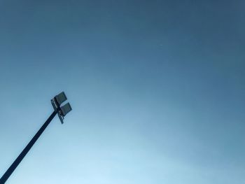 Low angle view of street light against blue sky