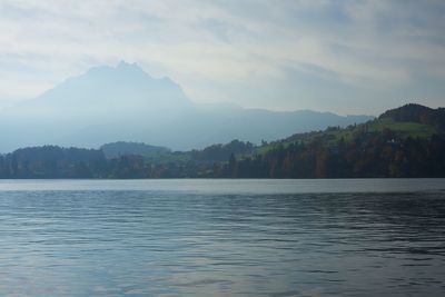 Scenic view of lake and mountains against sky
