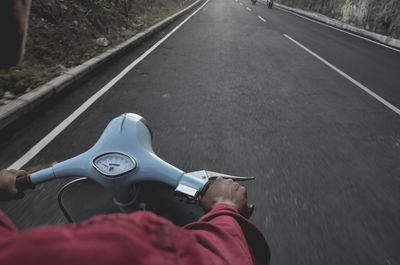 Man riding bicycle on road