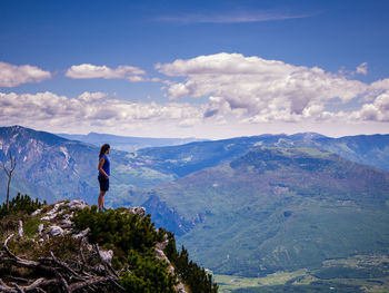 Man standing on mountain against sky