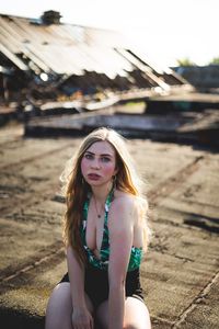 Portrait of young woman sitting outdoors