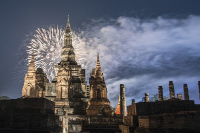 Low angle view of temple against buildings