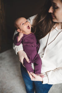 Smiling mother embracing baby