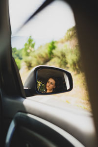 Portrait of man seen through car window