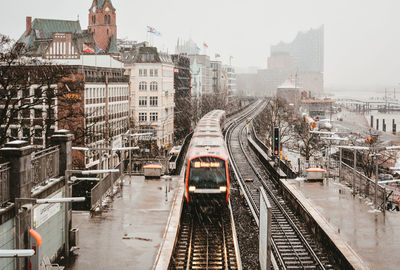 High angle view of railroad tracks in city against sky