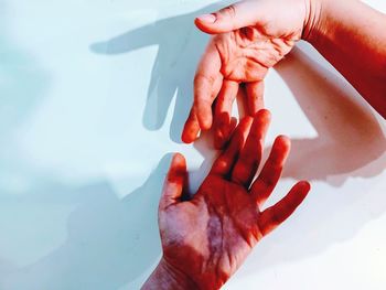 High angle view of people hands in water