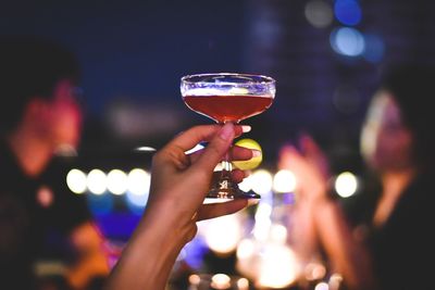 Cropped image of people holding glass