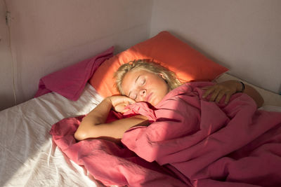 Young woman sleeping in bed