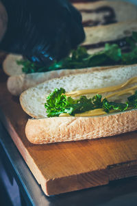 Sandwich in the making. fresh buns with sauces and letucce. food preparing from food track concept.