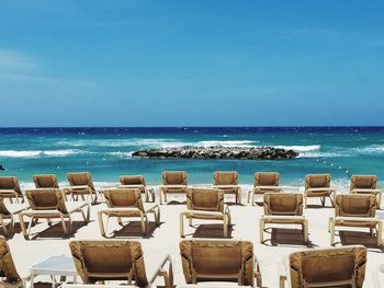Beach chairs facing the blue