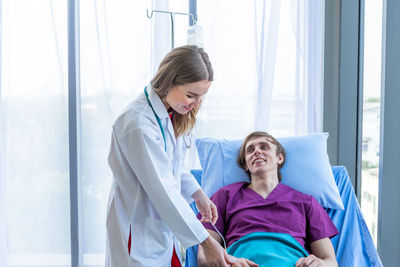 Female doctor examining patient in hospital