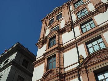 Low angle view of building against clear blue sky