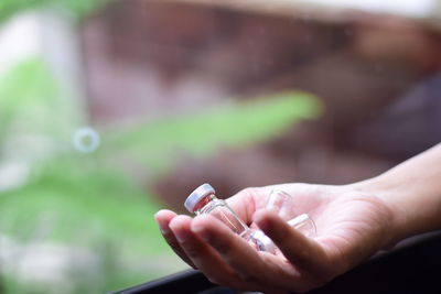 Close-up of hand holding cigarette