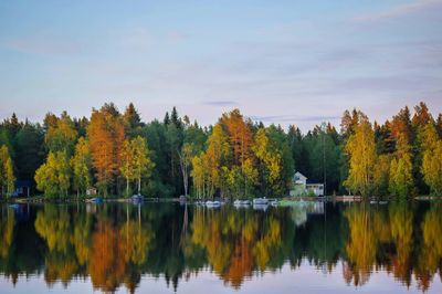 Reflection of trees in lake against sky during autumn