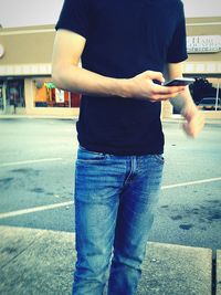 Rear view of man standing on road